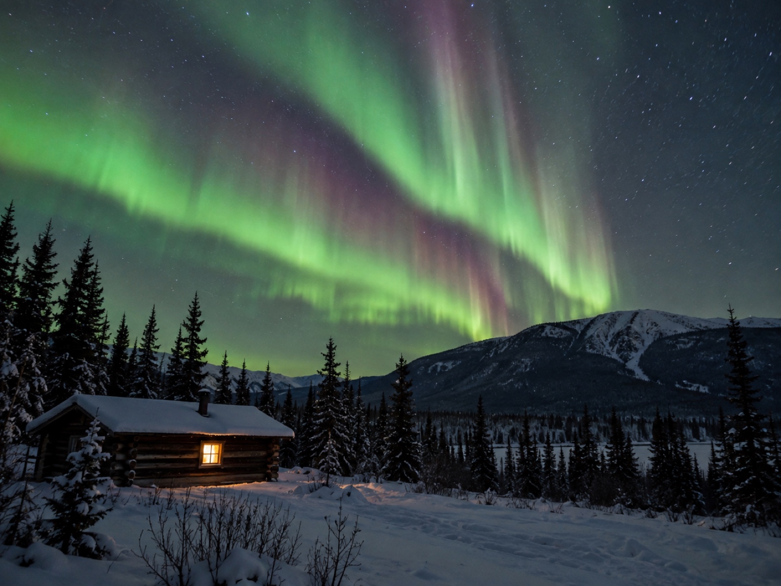 Aurora borealis above a snow-covered cabin near Whitehorse, Yukon