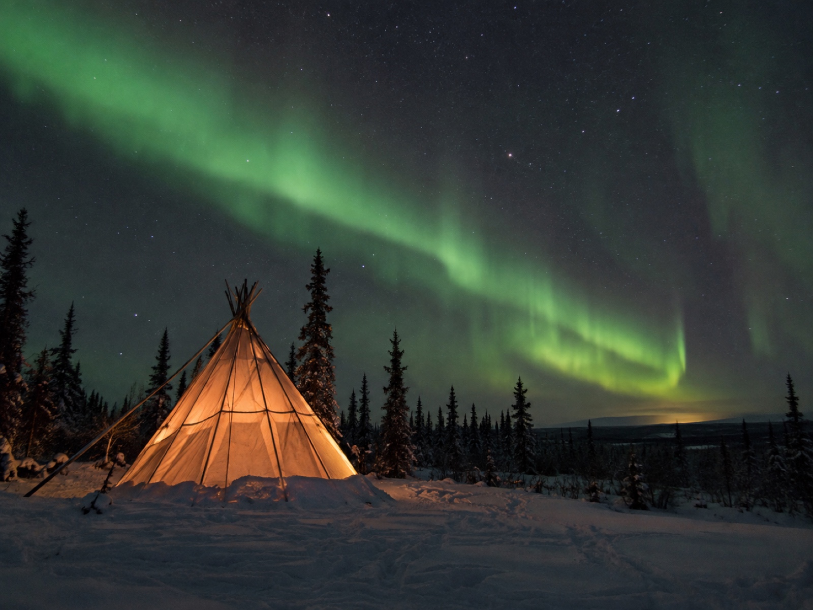 Aurora display over a heated viewing shelter outside Yellowknife, Northwest Territories